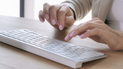 woman typing on computer keyboard, Modern Device Management | DXC Technology Insights